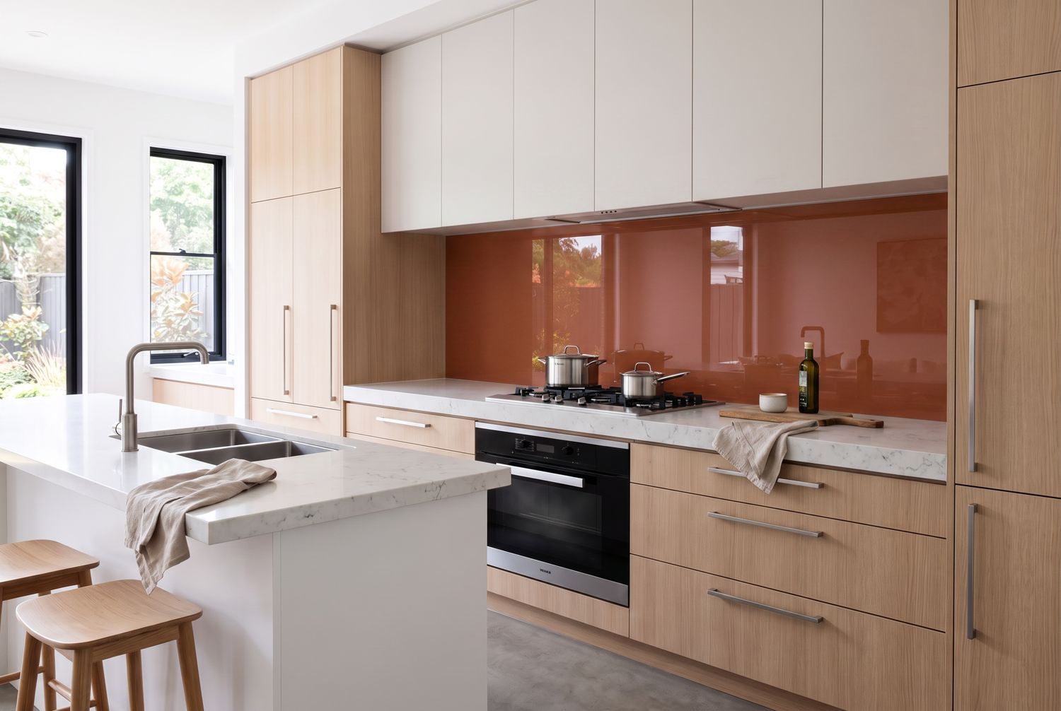 Kitchen with a terracotta glass splashback