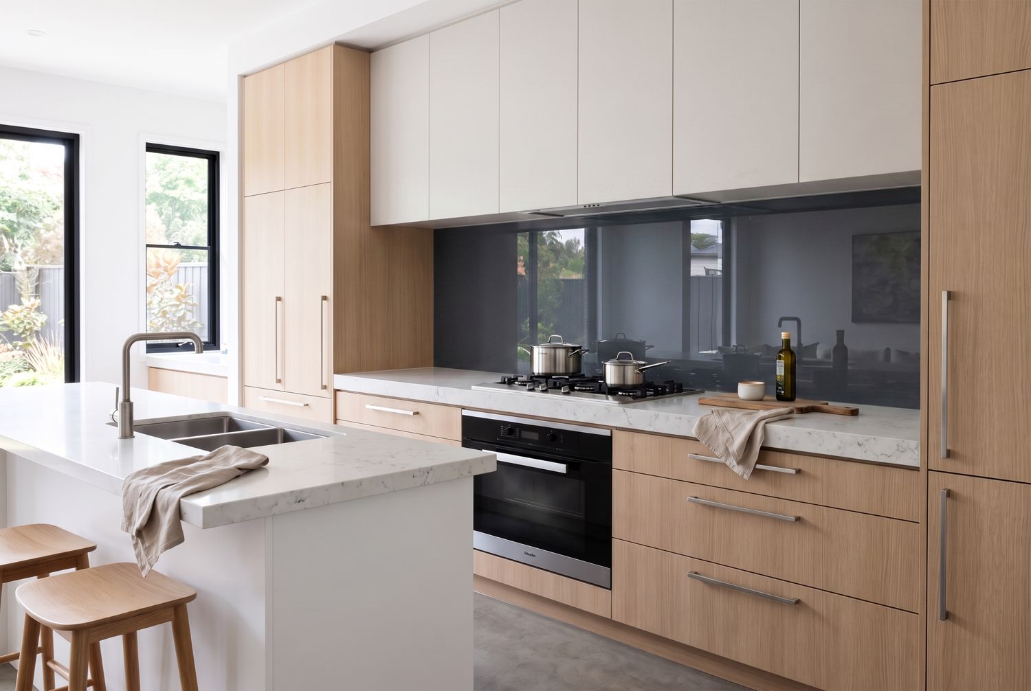 Kitchen with a charcoal glass splashback